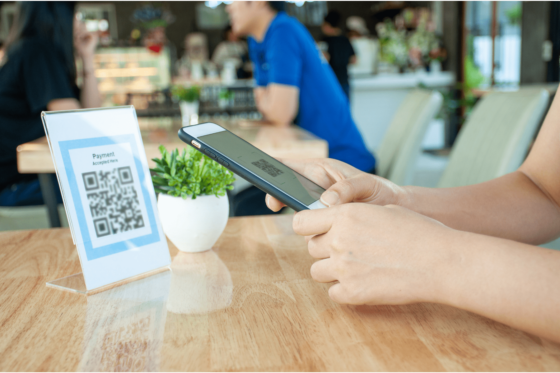 person using phone to scan a qr code in a restaurant